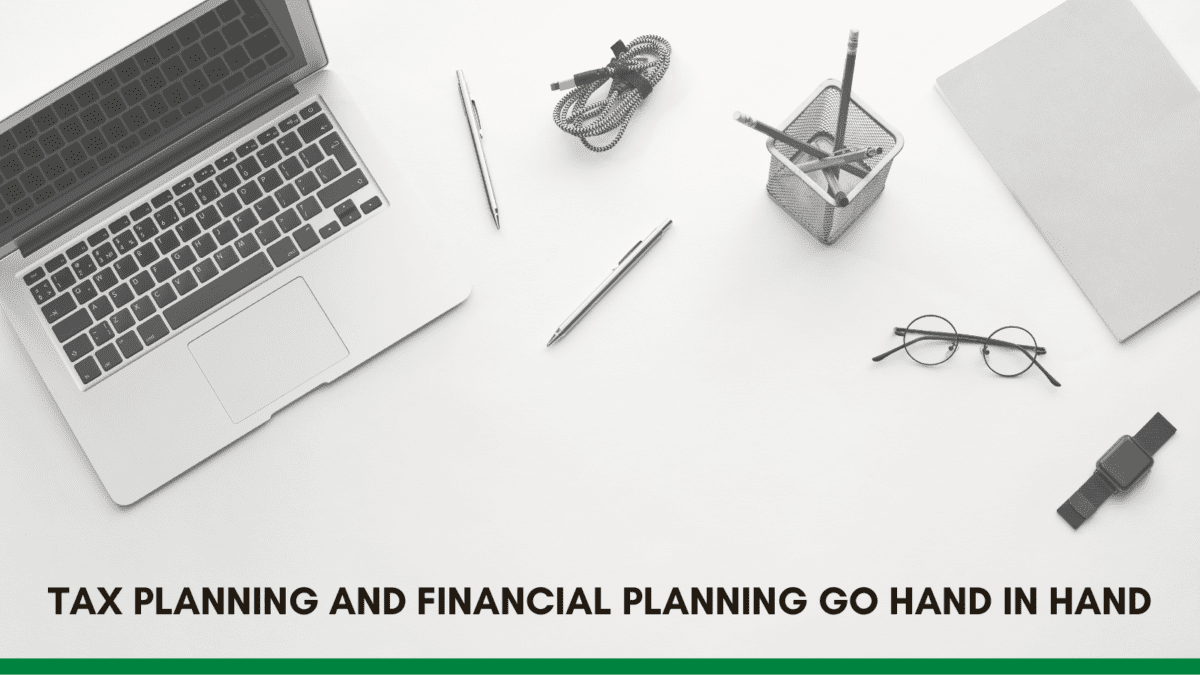 An overhead view of a workspace featuring a laptop, stationery, and a note, emphasizing the connection between tax and financial planning.