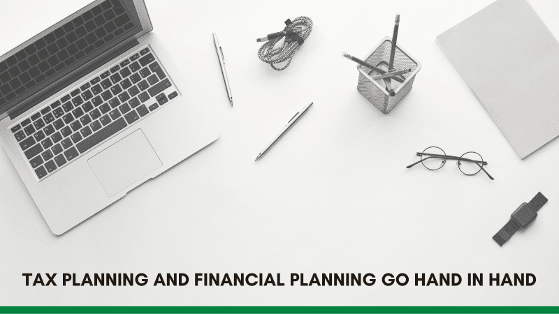 An overhead view of a workspace featuring a laptop, stationery, and a note, emphasizing the connection between tax and financial planning.