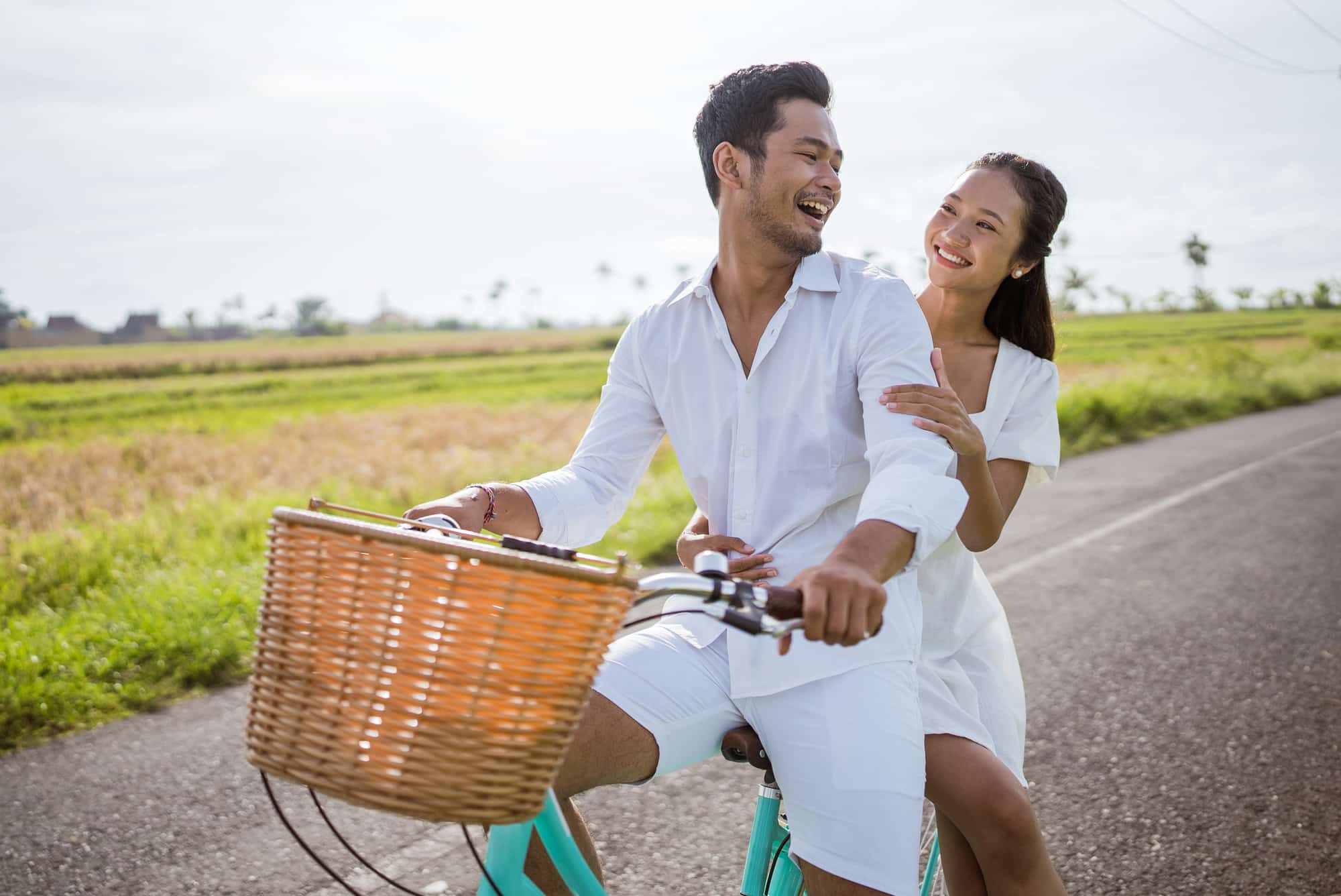 Happy Asian Couple on a bicycle